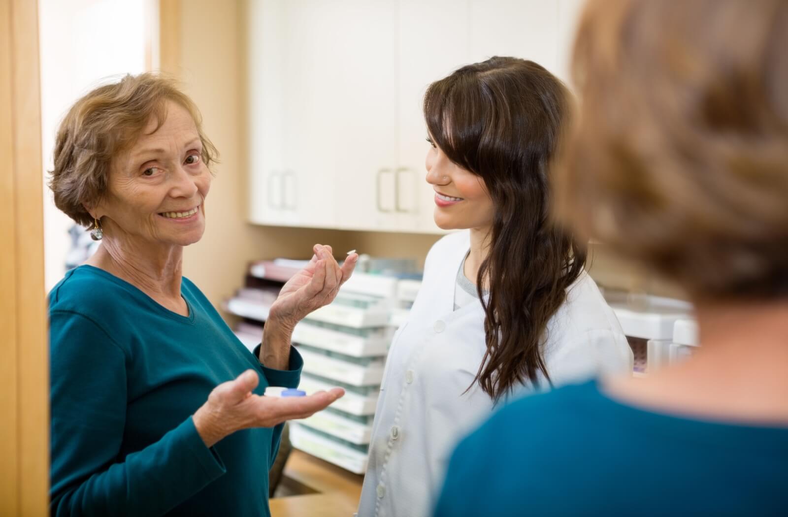 A mature patient trials multifocal contact lenses during her lens fitting.