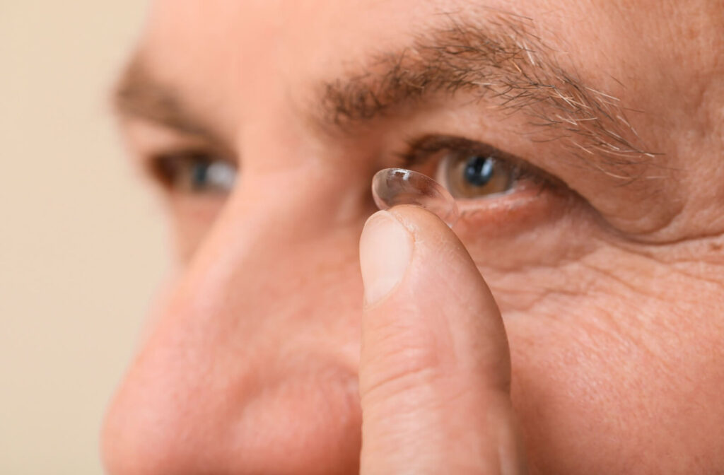 Closeup of a mature gentleman applying their multifocal contact lenses.