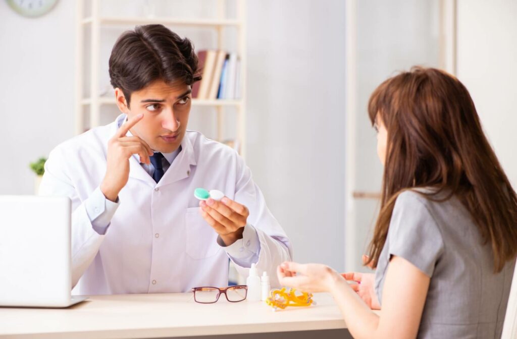 An optometrist discusses contact lens options with their patient during their contact lens fitting.