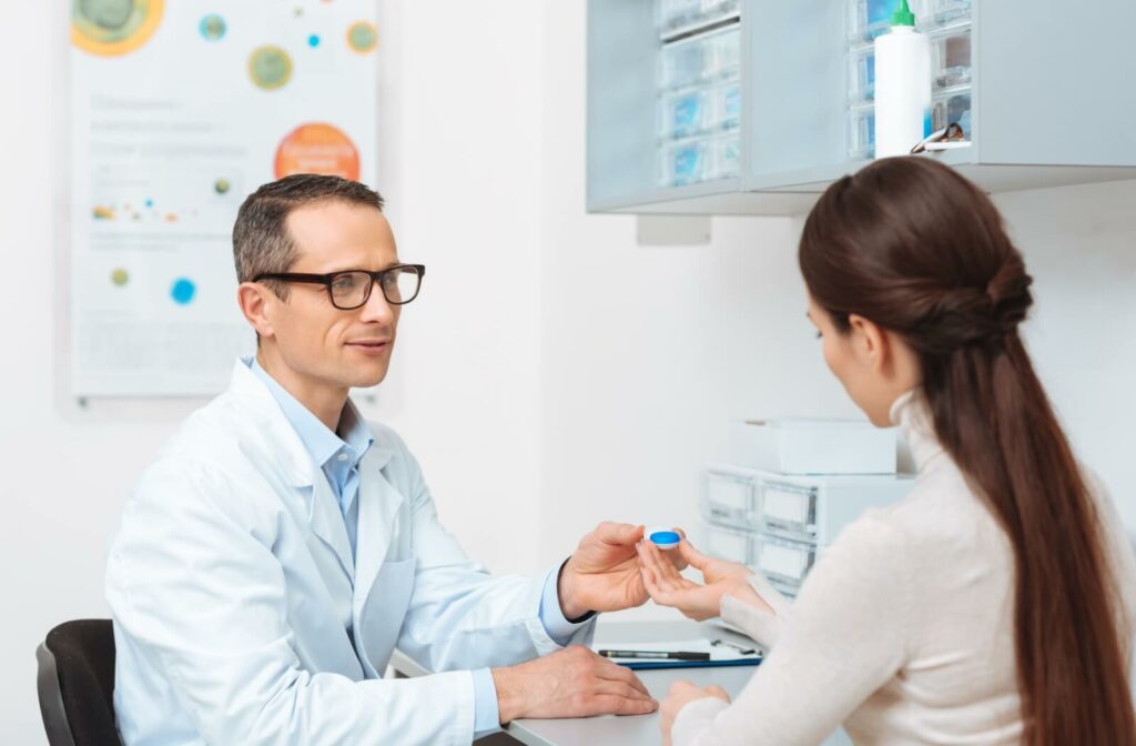 An optometrist explains proper scleral lens wear and care for their patient during their contact lens fitting.