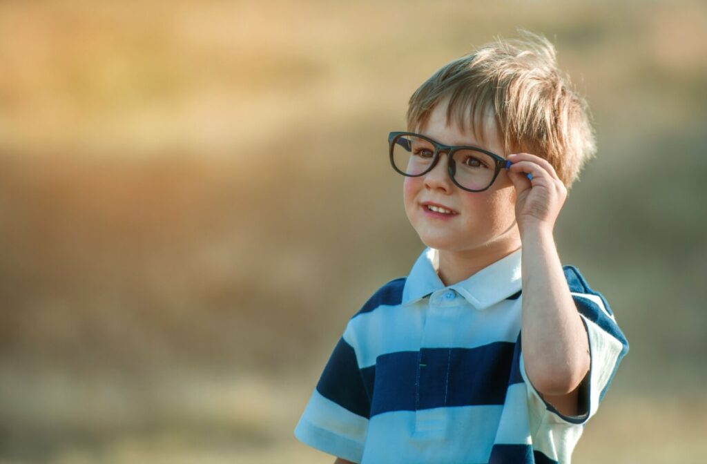 A small child wearing glasses with thick frames.