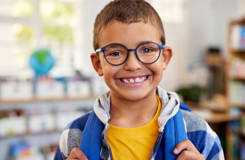 A child wearing glasses at school.